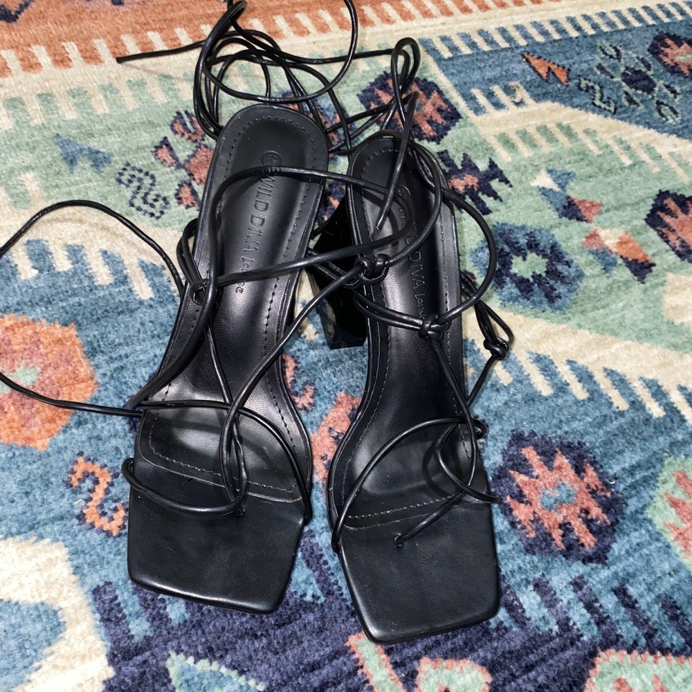 Black strap wide heels.